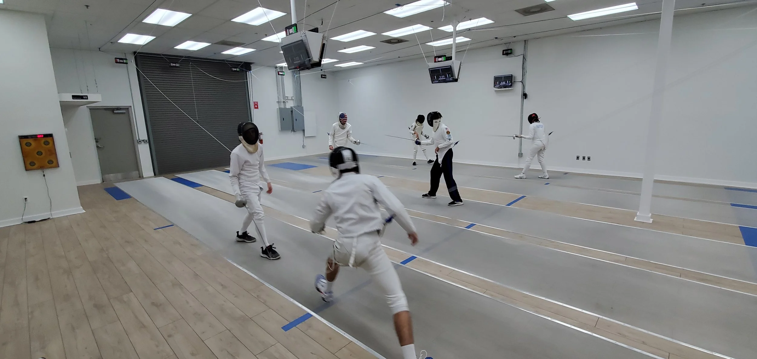 Young fencers training on the strip at Orlando Fencing Sports Center