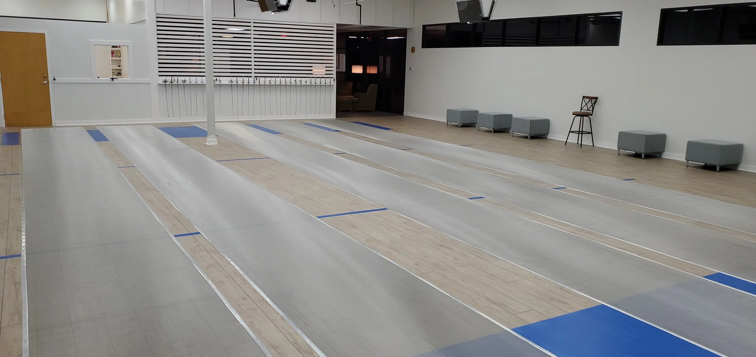 Interior of Orlando Fencing Sports Center showing five competition fencing strips