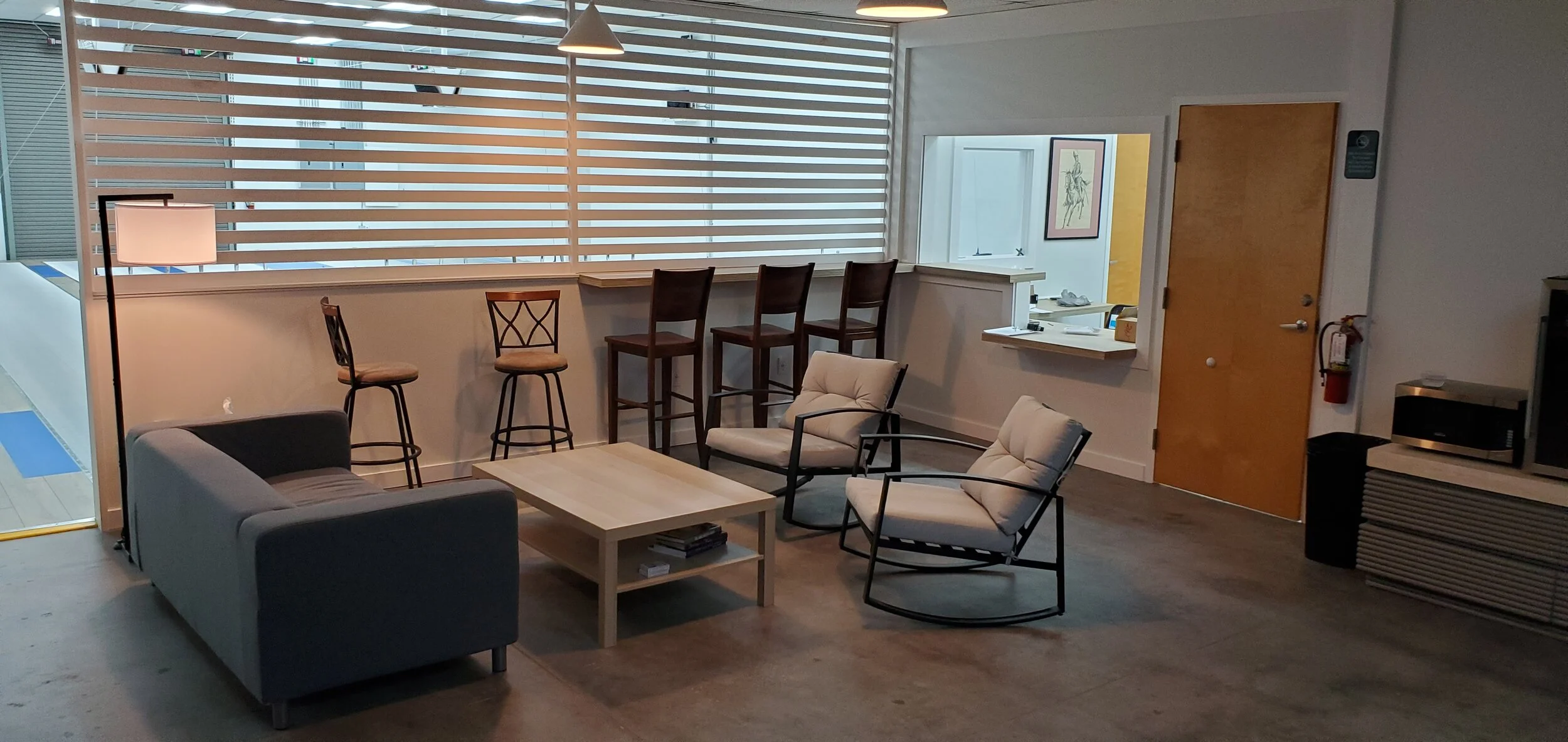 Visitors' lounge with seating and beverage bar at Orlando Fencing Sports Center